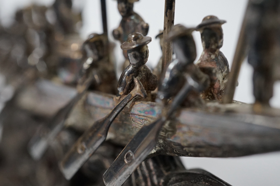 A Chinese white metal miniature model of a junk, length 11.2cm, on a wooden stand, a similar late 19th/early 20th century miniature filigree sedan chair and rickshaw by Kwan Wo and a Chinese white metal model of a boat w